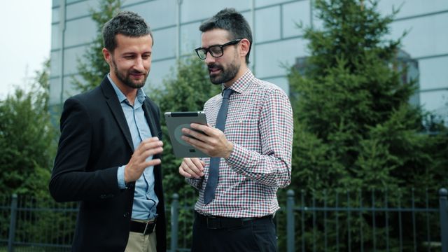 two people looking at a tablet together